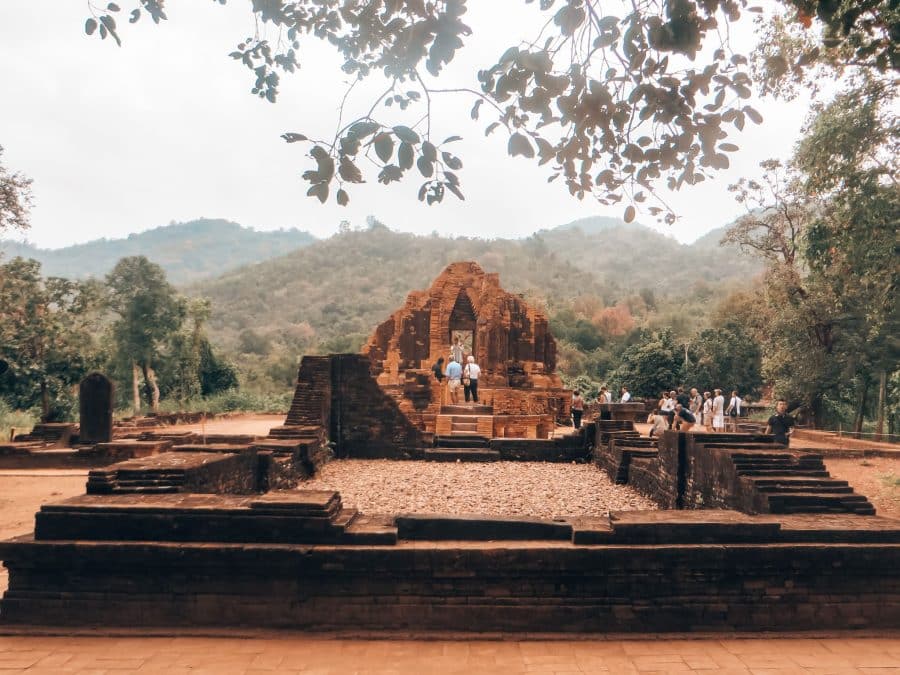 Ancient red brick ruins surrounded by thick lush jungle, My Son, places to visit in Hoi An, Vietnam