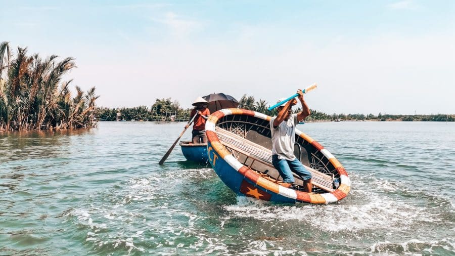 A local spinning and dancing in his bamboo boat in Hoi An, Vietnam