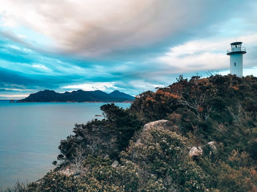 A white lighthouse standing above the ocean at sunrise, Cape Tourville Lighthouse, Freycinet National Park, Tasmania, Australia