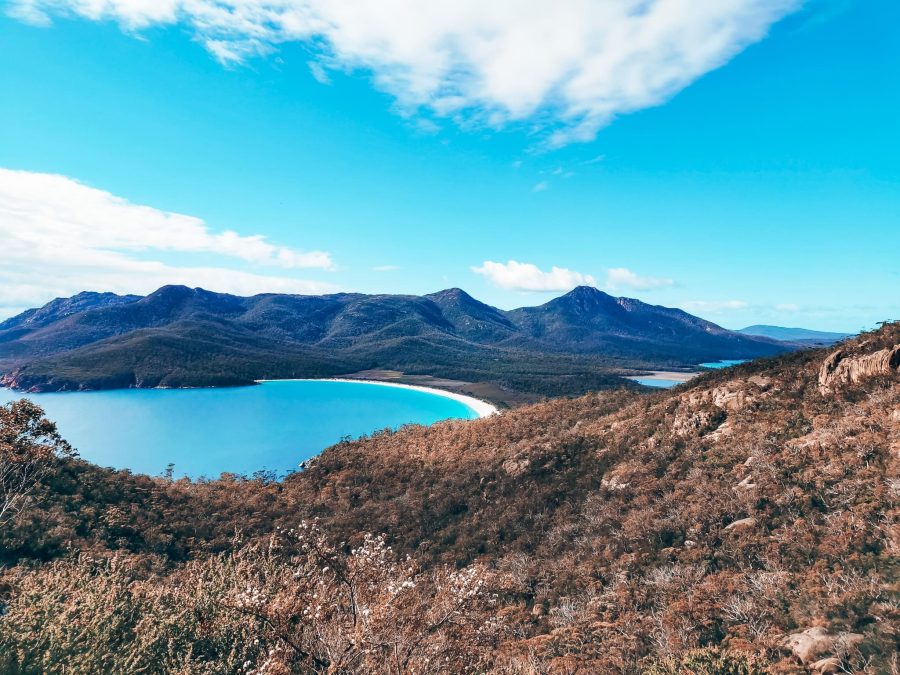 View over the striking turquoise water and mountains at Wineglass Bay, one of the best things to see in Tasmania, Australia