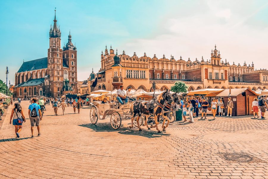 St Mary's Basilica, old architecture and a horse drawn carriage in Krakow Main Square, Poland