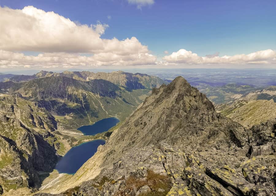 The view at Rysy Mountain summit over the surrounding jagged peaks with Czarny Staw and Morskie Oko lakes below, Zakopane, Poland