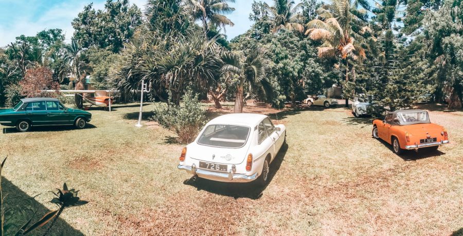 View from the restaurant at Chez Tante Athalie overlooking the gardens with dozens of vintage cars, Mauritius