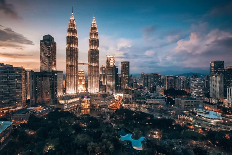 The Petronas Towers lit up at night with a park underneath, Kuala Lumpur, things to do in Malaysia