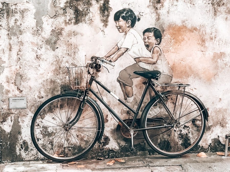 Street art in Penang, two children riding a bike on the side of a wall, Georgetown, places to visit in Malaysia