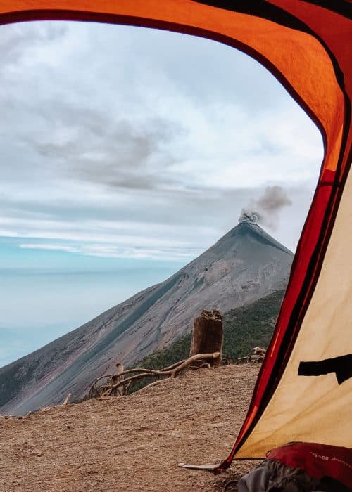 View from inside our tent at Volcan Acatenango Base Camp over to Volcan Fuego erupting in the distance; one of the best things to see in Guatemala