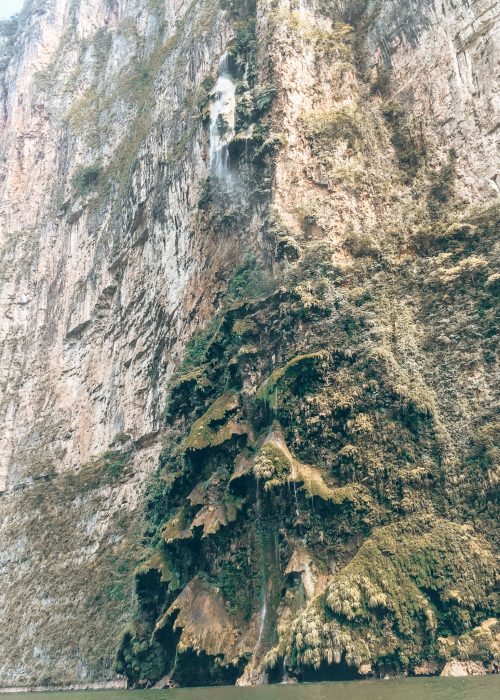 The fascinating Cascada Arbol de Navidad cascading down the imposing walls of the Canon del Sumidero, San Cristobal de las Casas