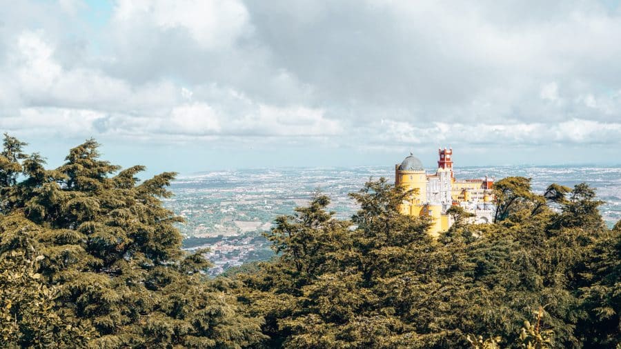 Pena Palace protruding through the forest is the highlight of any Sintra day Trip