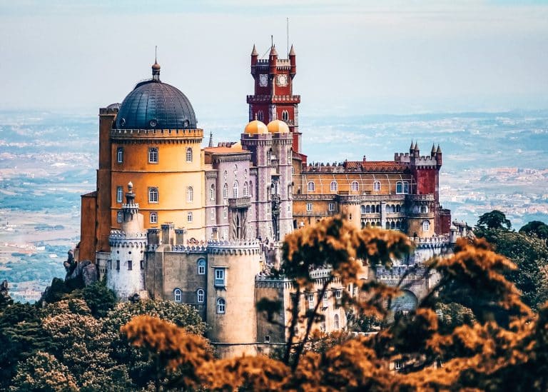 The magnificent Pena Palace protruding through the trees on a Sintra day trip from Lisbon