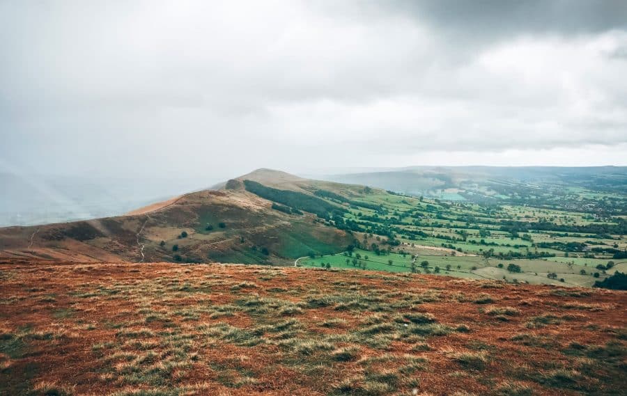 Mam Tor and the Great Ridge surrounded by views through the low clouds over the valley below, Peak District