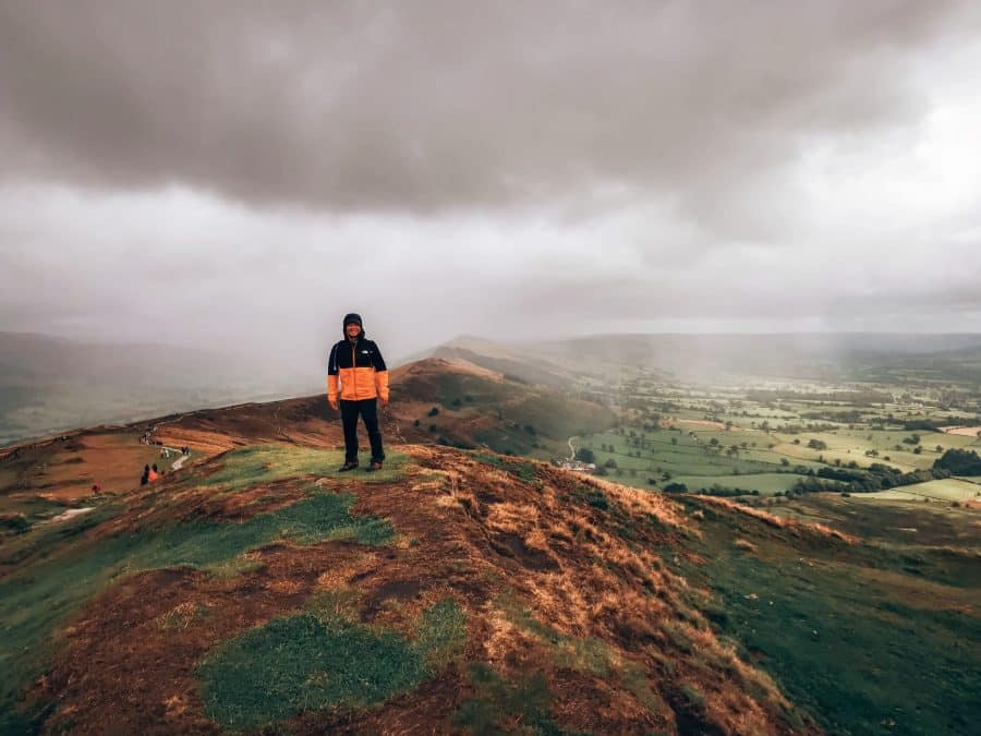 Andy stood on top of Mam Tor in the rain, Peak District, Derbyshire