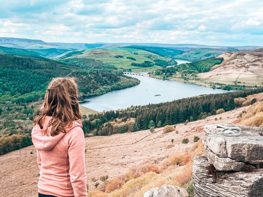 Helen looking out over the gorgeous Ladybower Reservoir from Bamford Edge, one of the best walks in the Peak District, Derbyshire