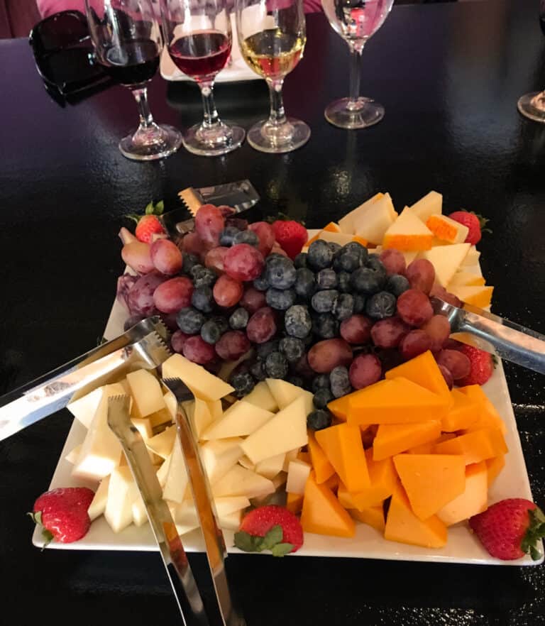 A platter of cheese and grapes next to a few glasses of wine on a food tour in Scottsdale wasn't what I expected on my Arizona road trip