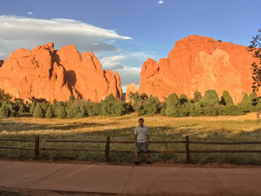 Andy in front of impressive golden rock formations at the Garden of the Gods on our Colorado road trip, Colorado Springs, USA