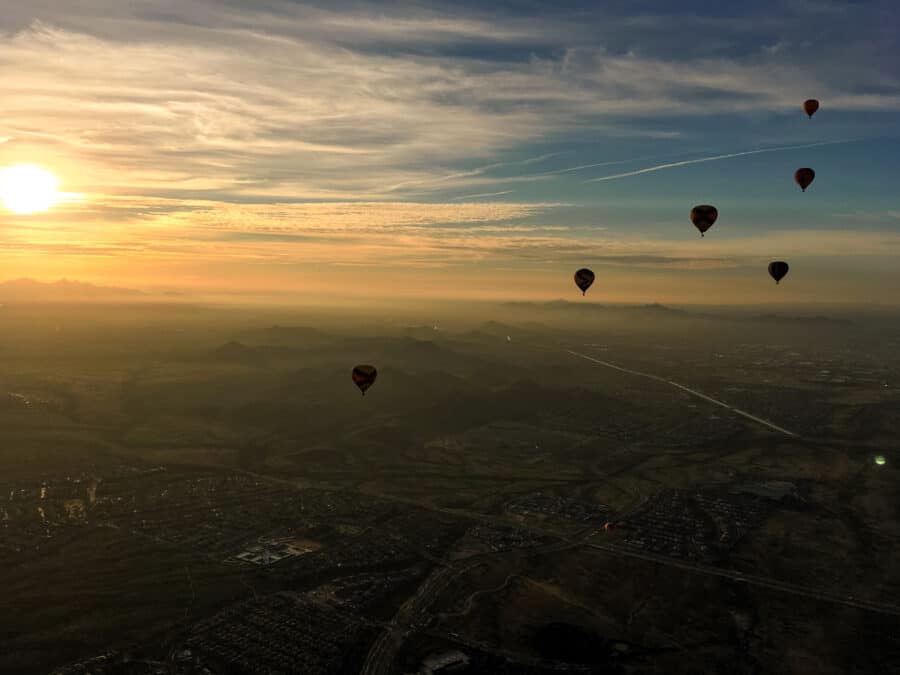 Sunrise in a hot air balloon with views across Phoenix and 6 other balloons is a must on your Arizona road trip!