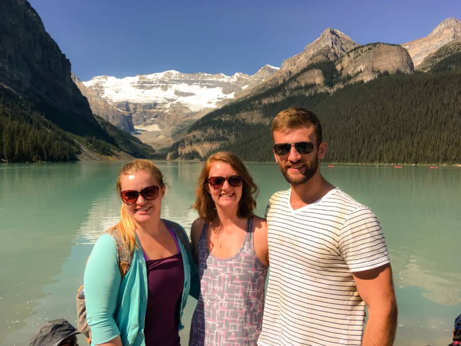 Helen with her brother and sister stood on the shore of Lake Louise with Victoria Glacier looming in the background, Banff, Canada
