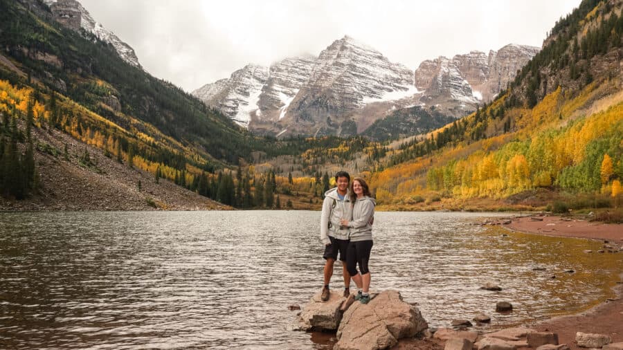 Andy and Helen stood underneath the snow-capped peaks of Maroon Bells, Aspen, our favourite place on our Colorado road trip, USA