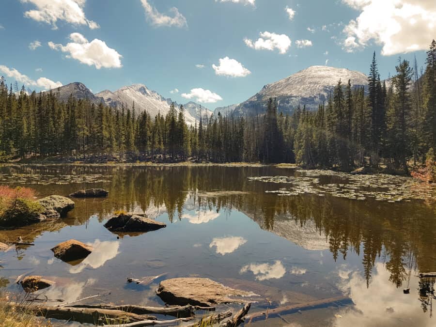 Nymph Lake in front of dramatic snow-capped peaks on our Colorado road trip, USA