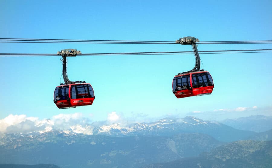 Two cable cars on the Peak 2 Peak Gondola with vast mountain ranges beyond, Whistler is a must between Calgary to Vancouver