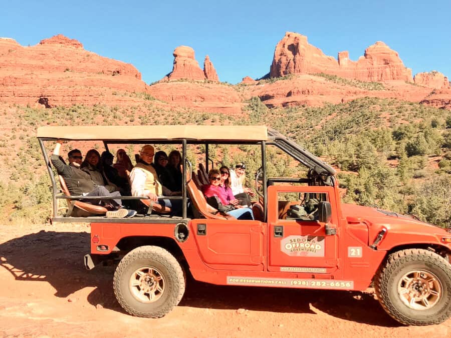 Group of us in the Sedona Offroad Adventures jeep with magnificent red rock formations behind us