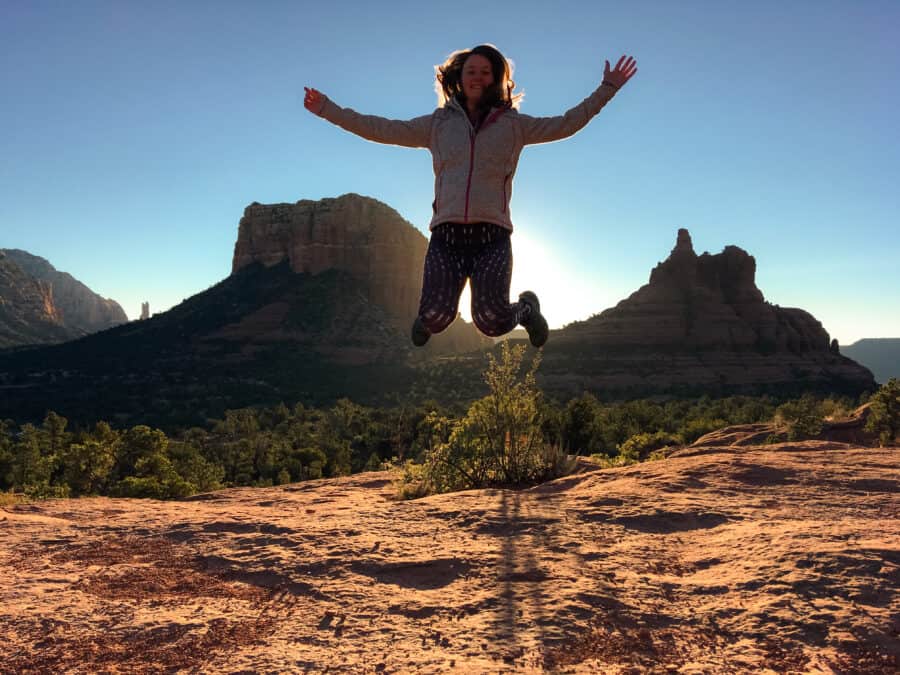 Helen jumping in the air amongst the magnificent red rocks of Sedona, Arizona