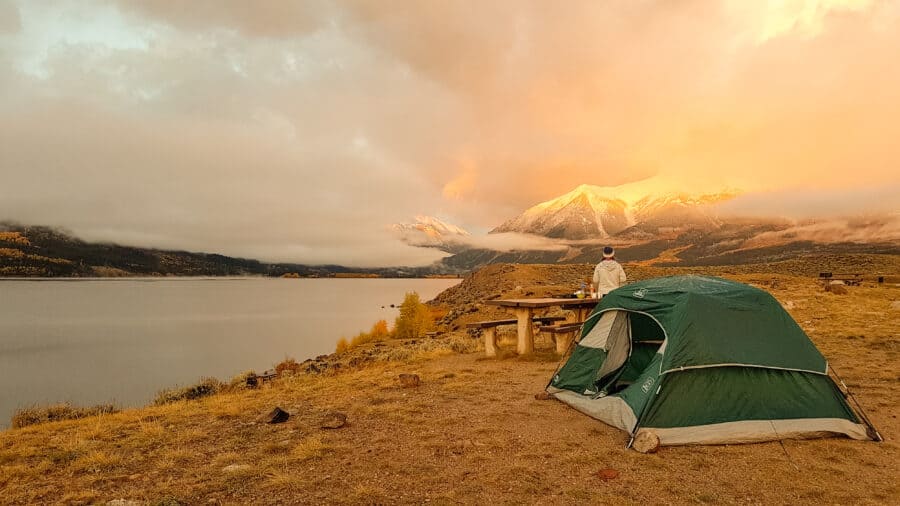 Making breakfast beneath snow-capped mountains next to Twin Lakes, Colorado, USA