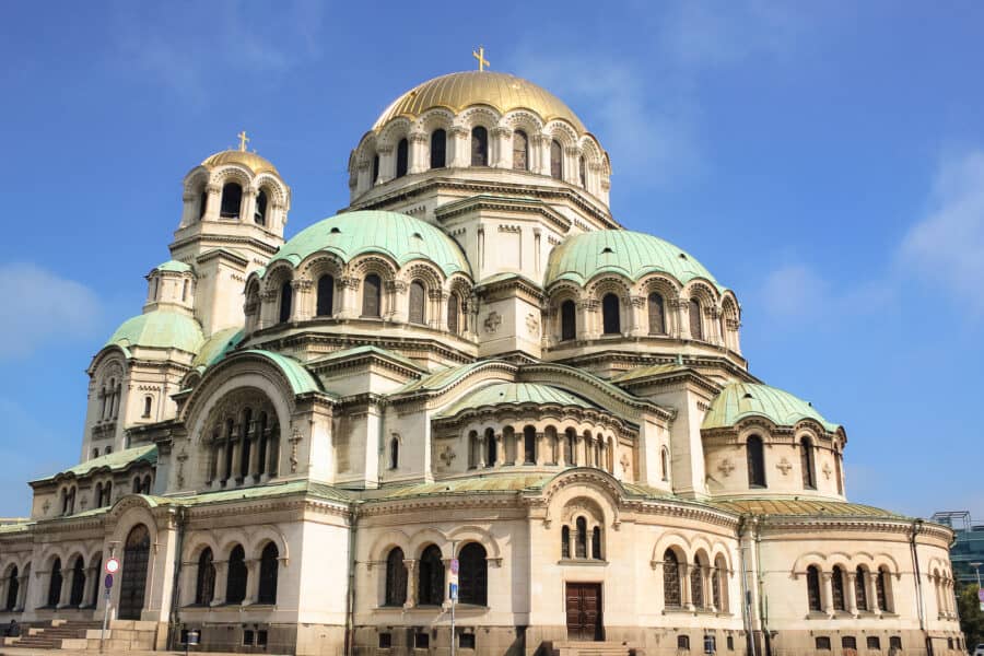 The impressive exterior of the Alexander Nevsky Cathedral with gold and teal domes, Sofia, Bulgaria