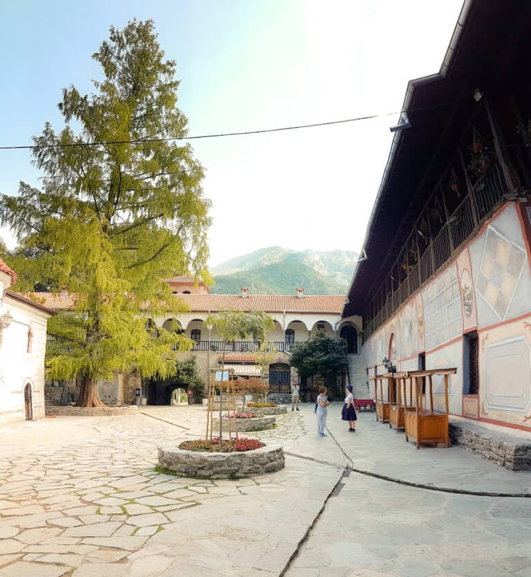 Picturesque courtyard at the Bachkovo Monastery in Plovdiv with a mountain backdrop is definitely one of the places to visit in Bulgaria