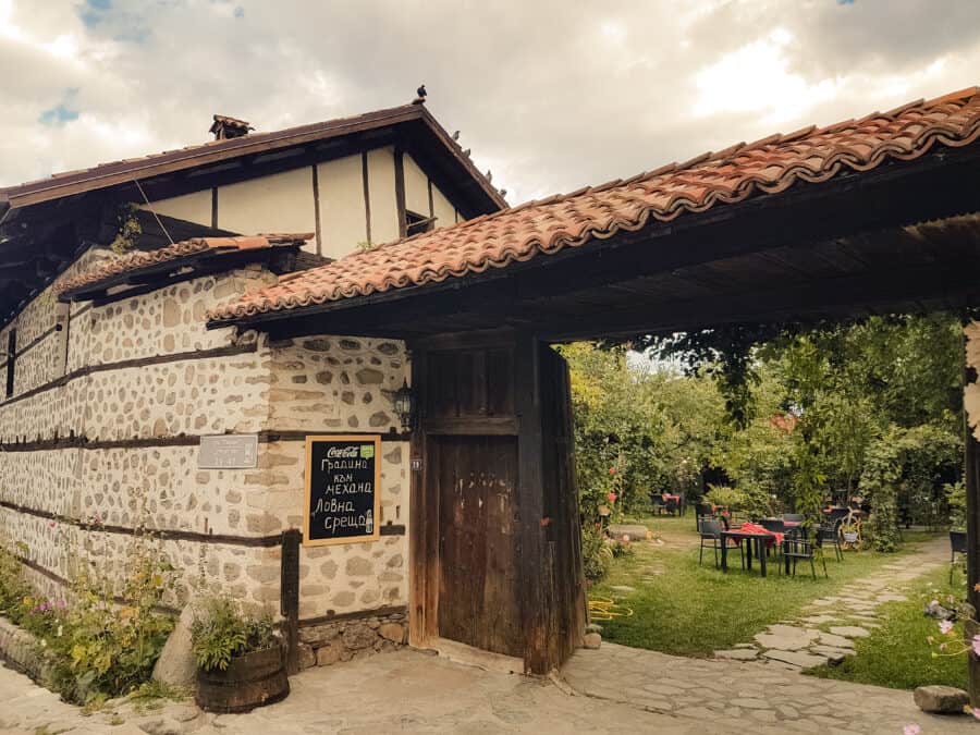 Exterior of a restaurant in Bansko with a beautiful garden should be on your list of places to visit in Bulgaria