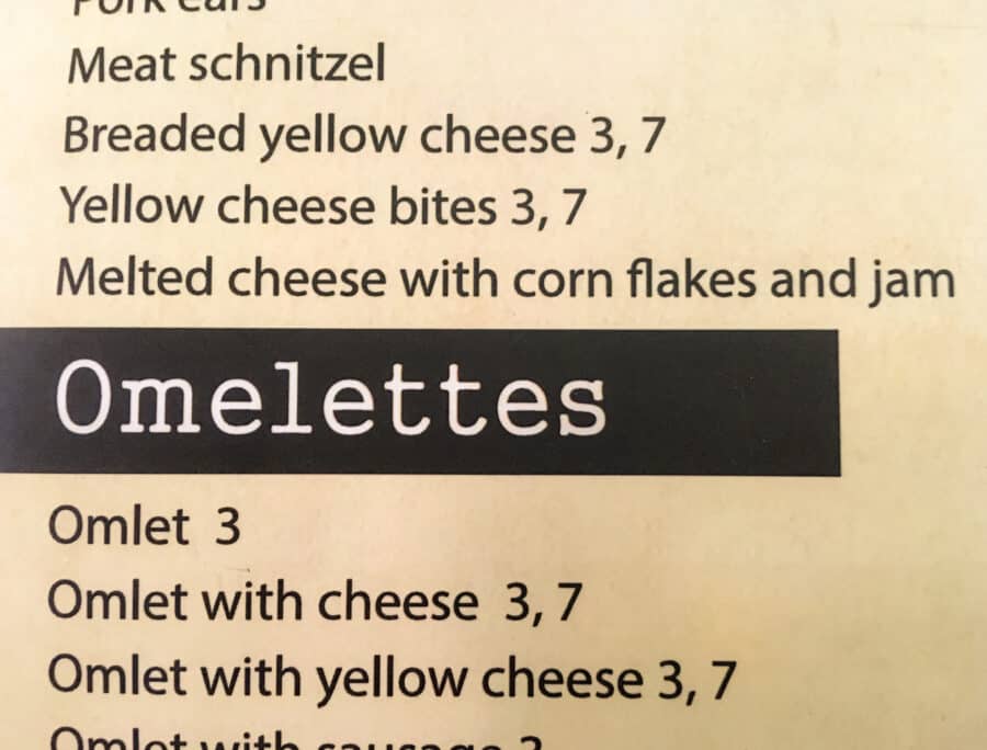 A food menu in a Bulgarian restaurant with cheese on everything