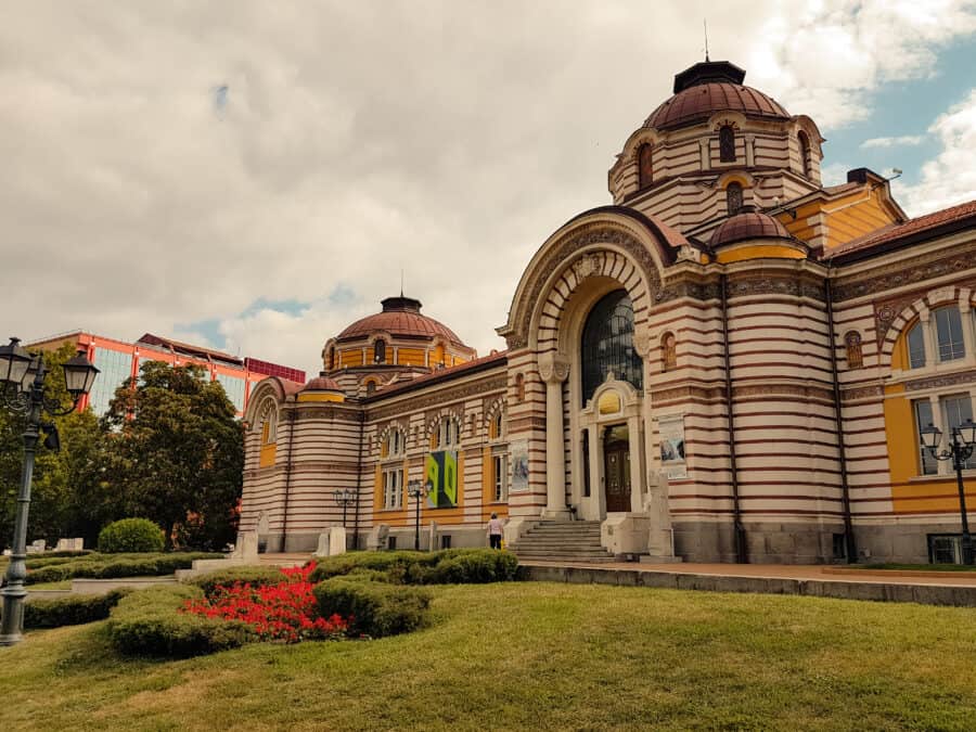 The yellow and red striped exterior of the Regional History Museum, Sofia, Bulgaria