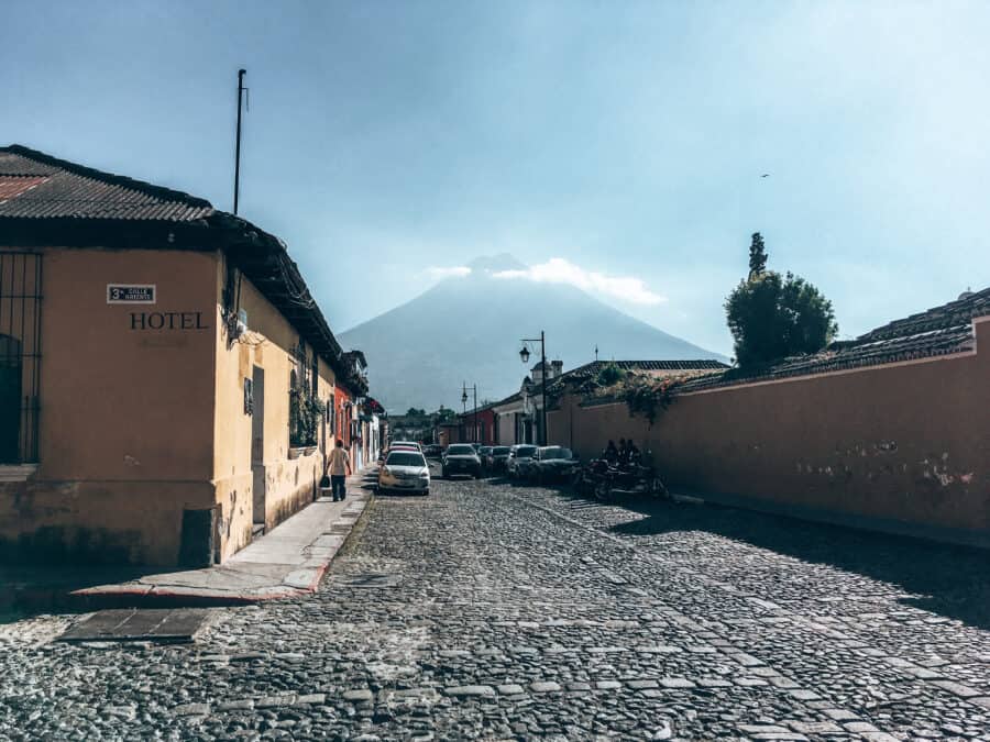 Colourful cobble streets of Antigua with Volcan Agua towering over the town, Guatemala