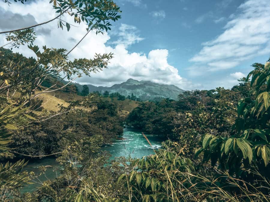 The thick, tropical Guatemalan jungle with an emerald river flowing through it, Lanquin