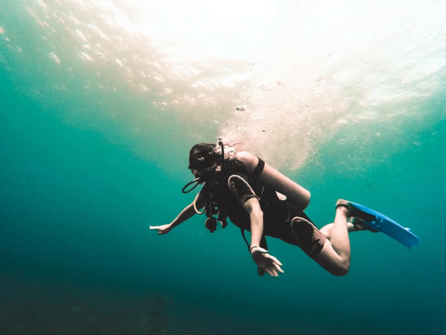 Helen scuba diving in crystal-clear water, Mauritius