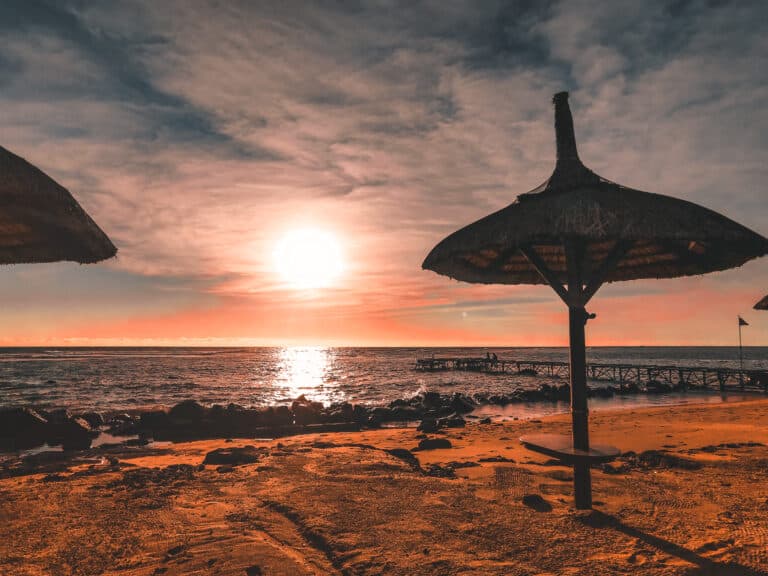 A sunset over the ocean lighting up the sky in pinks and reds on the West Coast of Mauritius