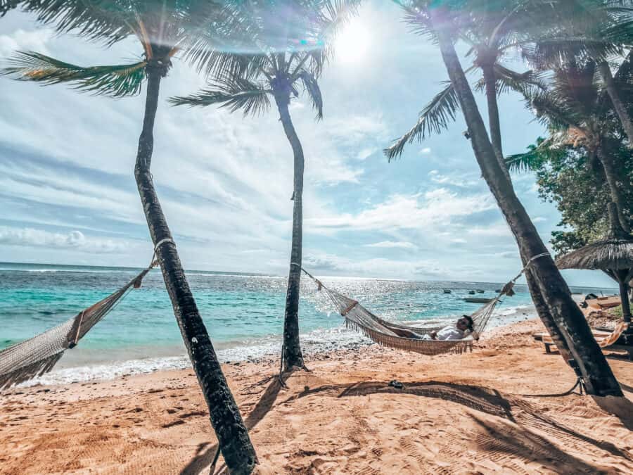 Andy lying in a hammock looking out to the emerald Indian Ocean at The Oberoi Mauritius