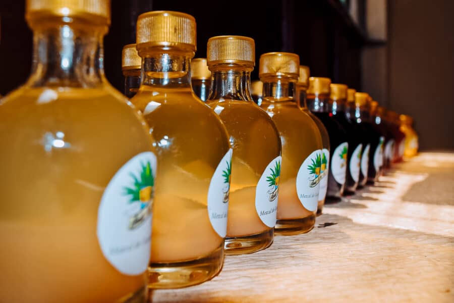 A row of different coloured Mezcal bottles in Oaxaca, Mexico