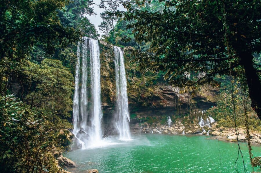 The emerald pool at the bottom of the thundering Misol-Ha Waterfall, Chiapas, Mexico