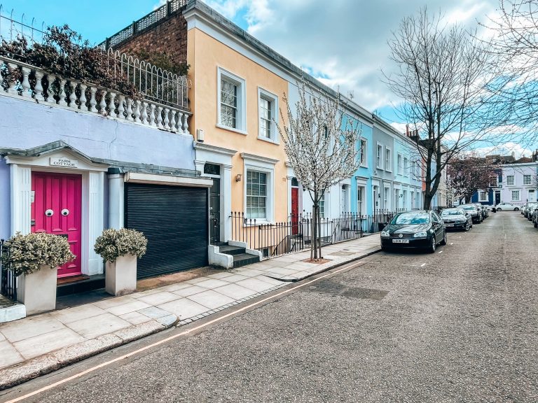 Googly eyes on a fushcia pink front door on Farm Place, one of Notting Hill's most colourful streets, London, England