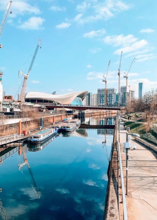 The peaceful River Lea running through Queen Elizabeth Olympic Park next to the aquatic centre, Stratford, East London, England