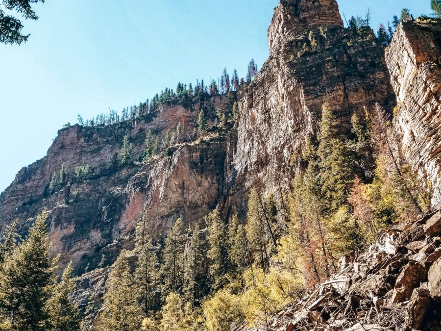 Huge towering cliffs covered in trees at Glenwood Canyon, Colorado