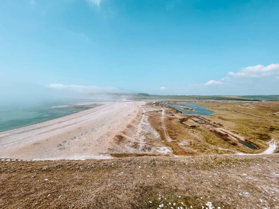 The view back across the vast Cuckmere Haven Beach on the Seven Sisters Walk in the South Downs National Park as a London day trip