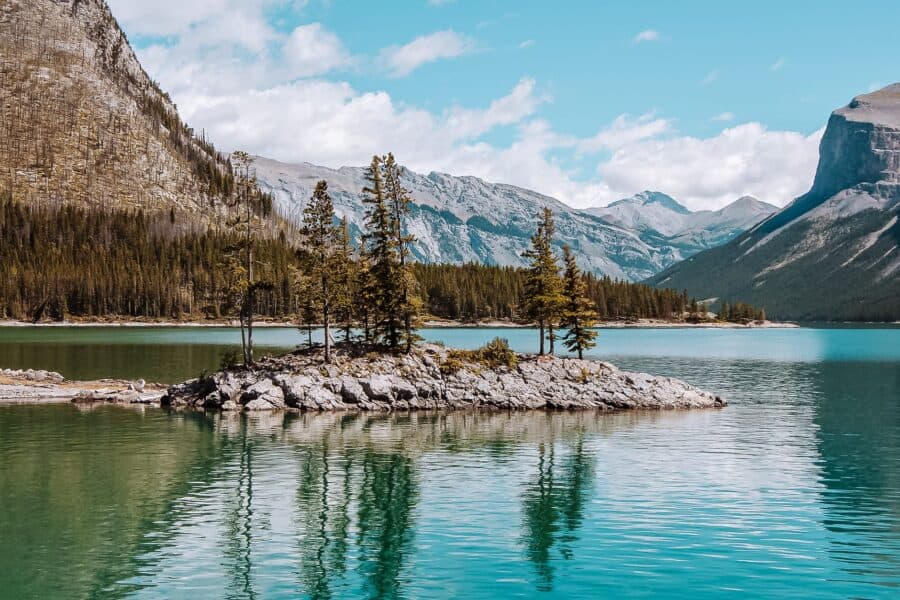 Lake Minnewanka Island sitting peacefully amongst towering mountain peaks, Banff National Park, Canada