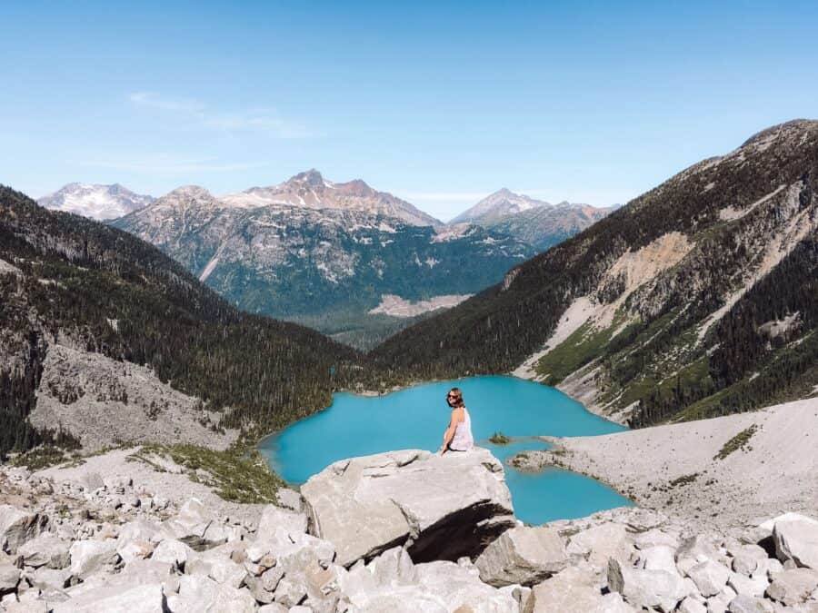 Helen sat near Matier Glacier overlooking Upper Joffre Lake and the neighbouring mountain peaks, Whistler, Canada