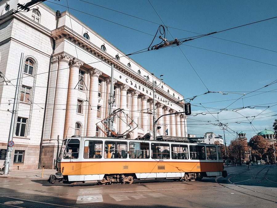 A bright yellow tram driving the streets of Sofia, Bulgaria