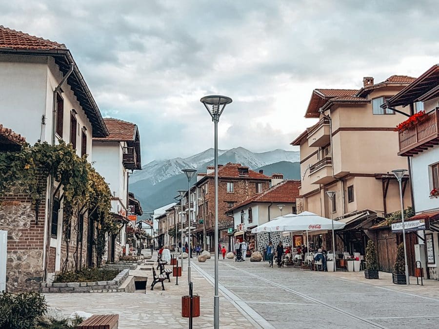 Pirin Street in Bansko with a dramatic mountain backdrop, Bulgaria