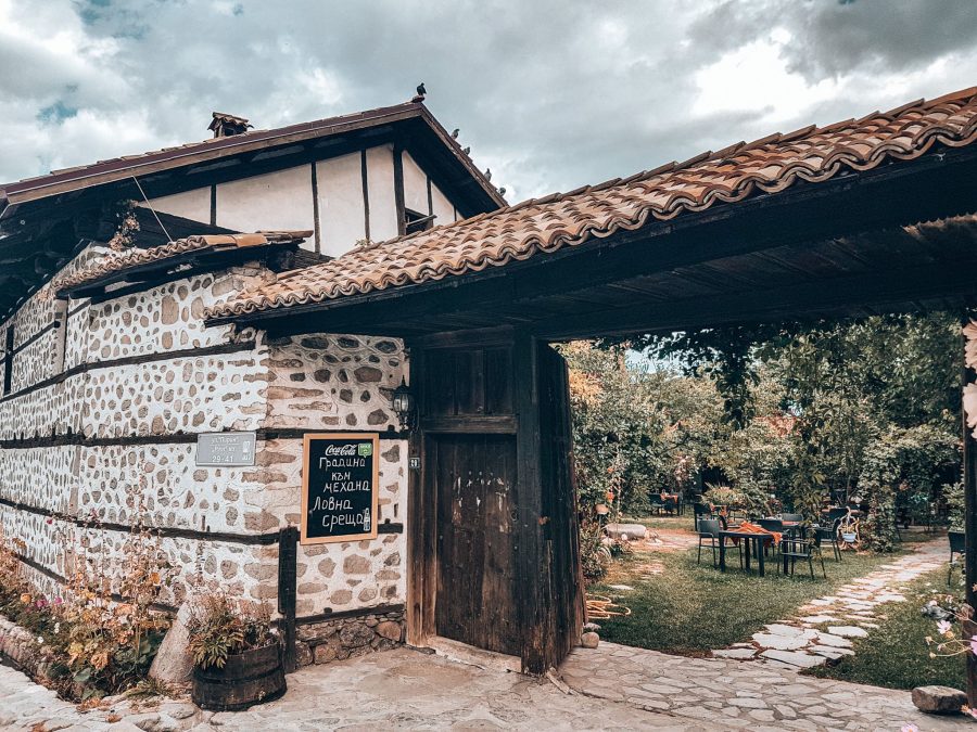 A tranquil and beautiful mehana garden with tables and chairs outside for dining, Bansko, things to do in Bulgaria