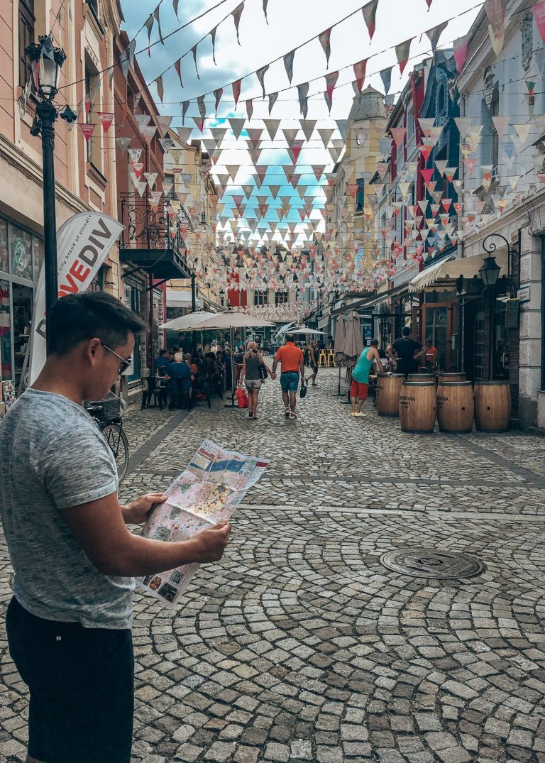 Andy looking at a map as he stands on the narrow cobbled streets in Kapana, Plovdiv, Bulgaria