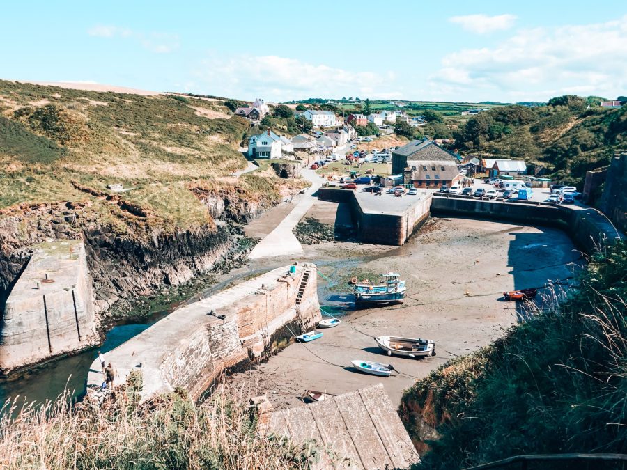 The picturesque coastal hamlet of Porthgain with boats in the harbour while the tide is out, Pembrokeshire, Wales