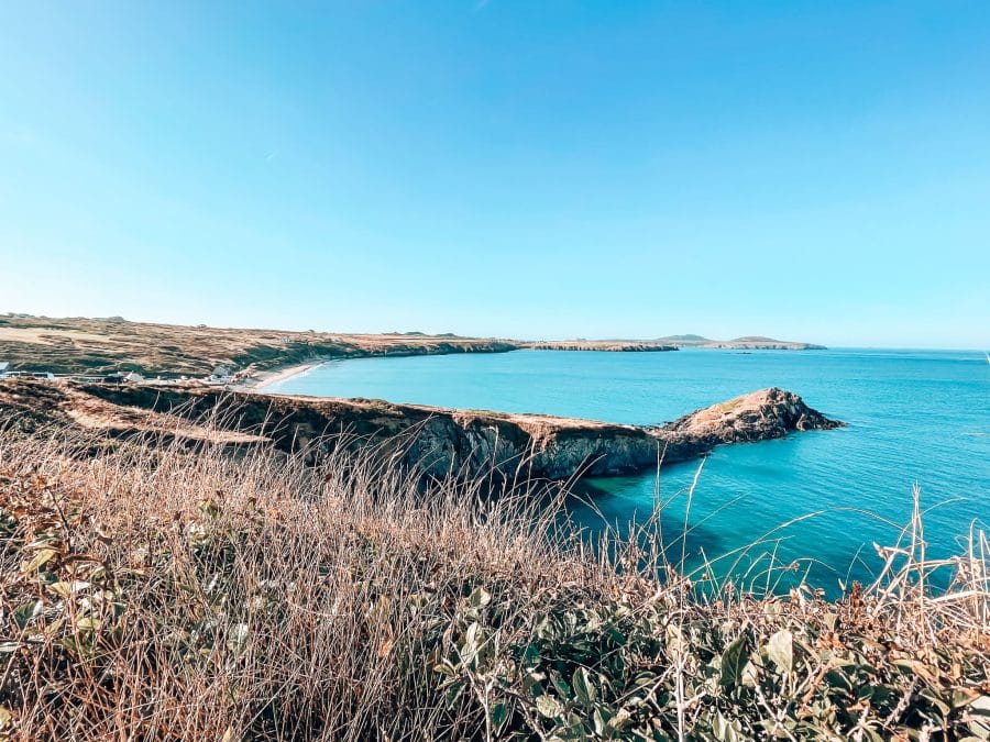 Striking turquoise water lapping at the golden sands of Whitesands Bay, Pembrokeshire Coast Path, Wales